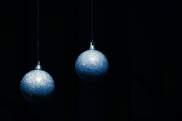 Two Christmas balls on dark background. Trend color of 2020 - Classic Blue