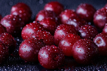 Fresh washed cherry berries with water drops on a background