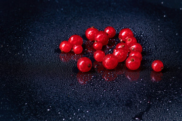 Fresh washed berries of red currant.with water drops on the background