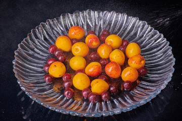 Fresh washed apricots fruits with water drops on the table