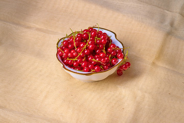Fresh washed berries of red currant on the background