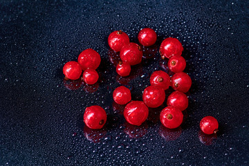 Fresh washed berries of red currant.with water drops on the background