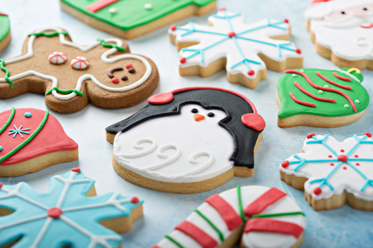 Christmas Sugar Cookies Decorated With Royal Icing With A Penguin Cookie In The Middle