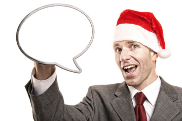 Cheerful businessman wearing a holiday Santa hat holding a blank speech bubble with copy space on white background
