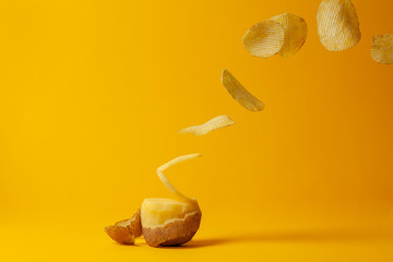 potato chips fly on a yellow background, the process of making chips, fast food levitation