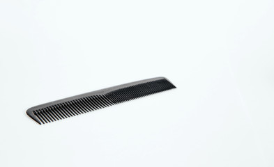 Black hair comb on a light background. Fashion and beauty concept.