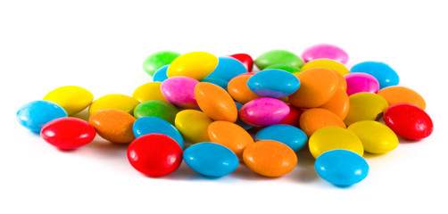 colored round candies on a white background