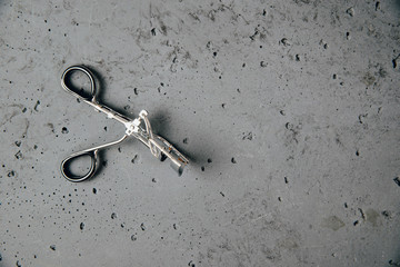Scissors for applying eyelashes. Fashion and beauty concept. Women's makeup.