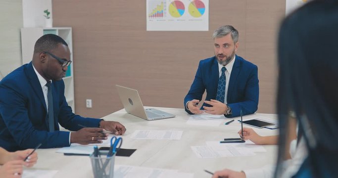 Dark-skinned businessman at a briefing in a modern business center. Meeting of financial directors, planning.