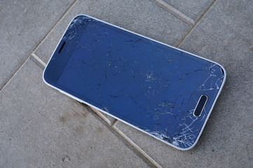 broken glass black smartphone on the sidewalk