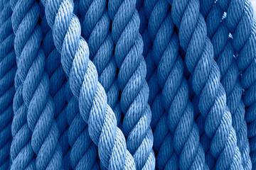 Trend color 2020 classic blue, top view, layout for design. Vintage skein of rope on a ship. Cable...