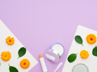 fresh flowers and green leaves on white purple papers