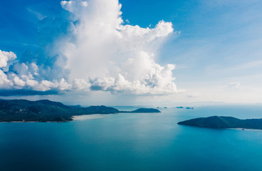 Bird's eye view of picturesque uninhabited islands surrounded by pure nature. Beautiful blue sky with white clouds. Breathtaking scenery landscape with sea