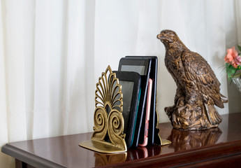 Depiction of a modern home library with e books between bookends on a table 