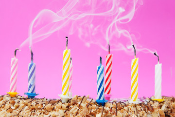 Smoke over the extinguished candles on a festive cake. Holiday concept, make wishes, end of...