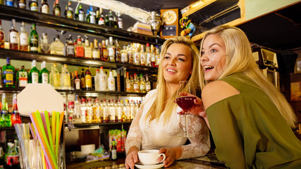 Girl with alcohol glass in pub club