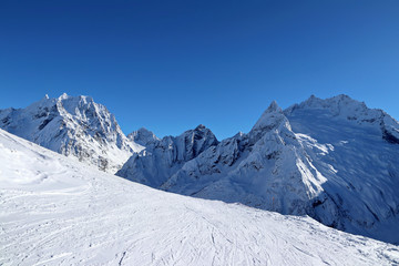 Fototapeta na wymiar Snowy Mountains peaks and the blue sky Caucasus