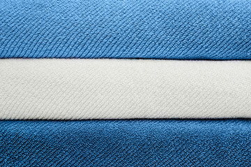 Fototapeta premium Stack of blue and whit towels. Copy space for text