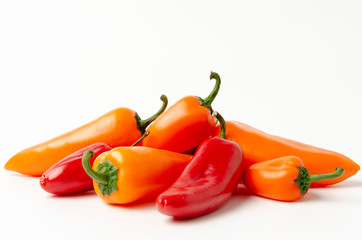 Red and orange peppers isolated on white
