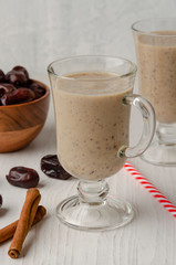 Glasses of date milkshake with cinnamon and