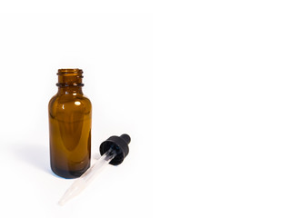 Cannabis extract oil, known as CBD, in an orange tincture bottle on a plain white background