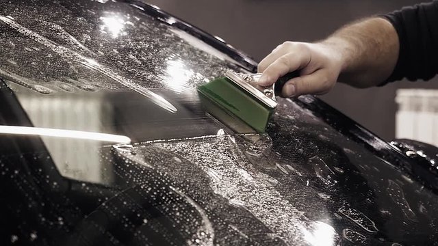 gluing armor on the windshield of the car