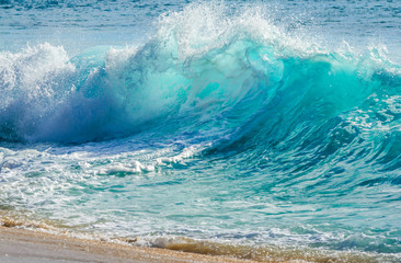 Turquoise colored breaking wave seascape on the beach - 307756223