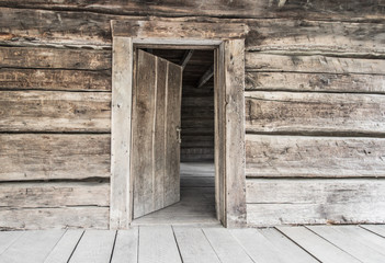 Open Front Door. Rustic abandoned log cabin with open front door in the Great Smoky Mountains. - Powered by Adobe