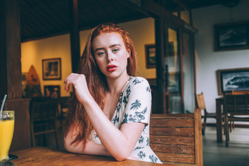 Sensual woman at table in cafe