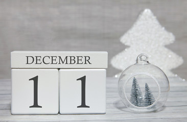 Cube with text from numbers and a month, December 11, the end of the year and summing up.