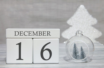 Cube with text from numbers and a month, December 16, the end of the year and summing up.