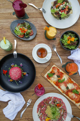 Various healthy vegetarian dishes served on the wooden table