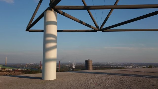 White smoke coming out from factory chimney with steel structure in the foreground