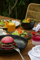Various healthy vegetarian dishes served on the wooden table