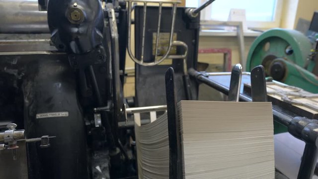 Printed sheets of paper are served in the printing press