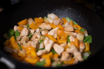 chicken and vegetables in a frying pan
