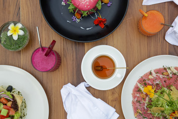 Various healthy vegetarian dishes served on the wooden table