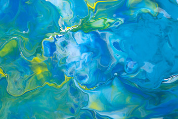 Blue and yellow acrylic liquid paint abstract background