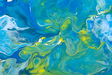 Fototapeta na wymiar Blue and yellow acrylic liquid paint abstract surface