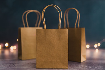 marketing and purchases concept, group of shopping bags with fairy lights bokeh shot at shallow...