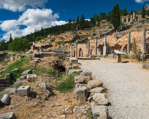 Fototapeta na wymiar Scenic landscape with road to ancient ruins of the Archaeological Site in Delphi, Greece. Entrance view