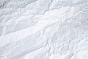 white and gray crumpled paper texture background. crush paper so that it becomes creased and wrinkled.