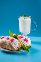 kefir is decorated with a leaf of mint, a fermented drink. Air cake on a saucer.