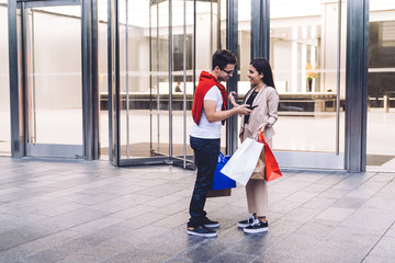 Joyful and happy couple talking after shopping