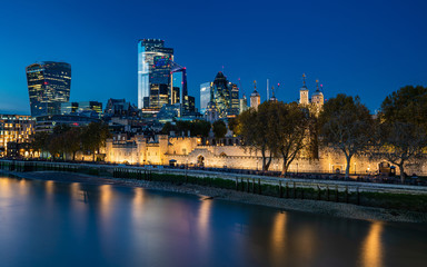The City of London at night with the Tower and Thames in the foreground