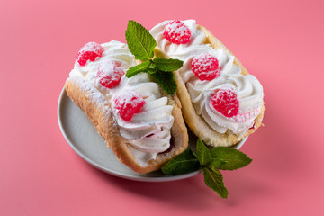 Airy raspberry cake in a plate on a pink background