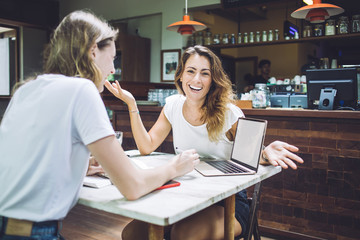 Cheerful young attractive female laughing and looking at camera