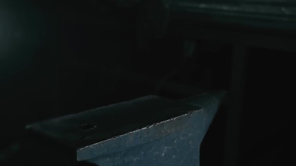 Forge workshop. Smithy manual production. Hands of smith with hammer hit on glowing hot metal, on the anvil, the forging process. Blacksmith makes iron products for manufacture of fireplace, stove.