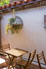 Old World patio set next to stucco wall