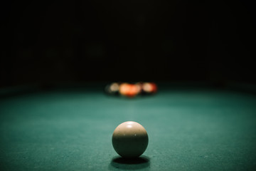 Billiards table with balls and cue ball set up for break